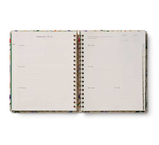 Open planner with floral design on a white background