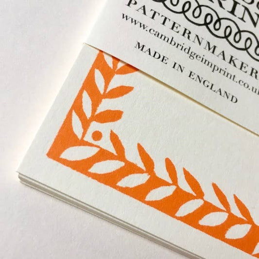 Booklet with orange and white leaf pattern and 'Cambridge Imprint' branding on a white background