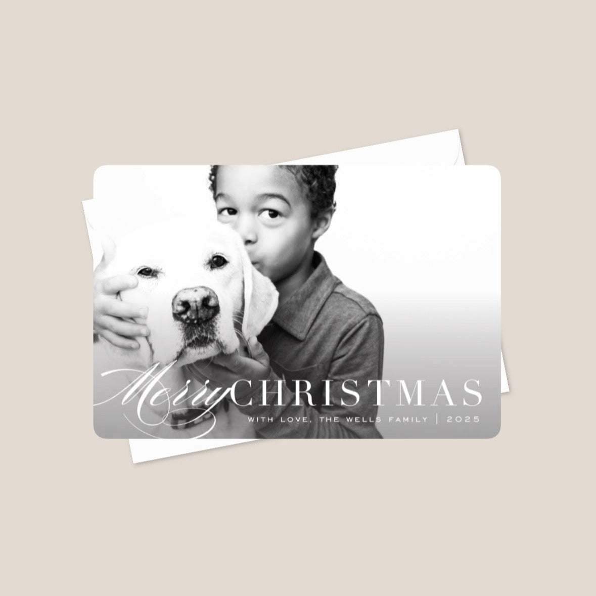 Christmas card with a photo of a child holding a dog and the text 'Merry Christmas'