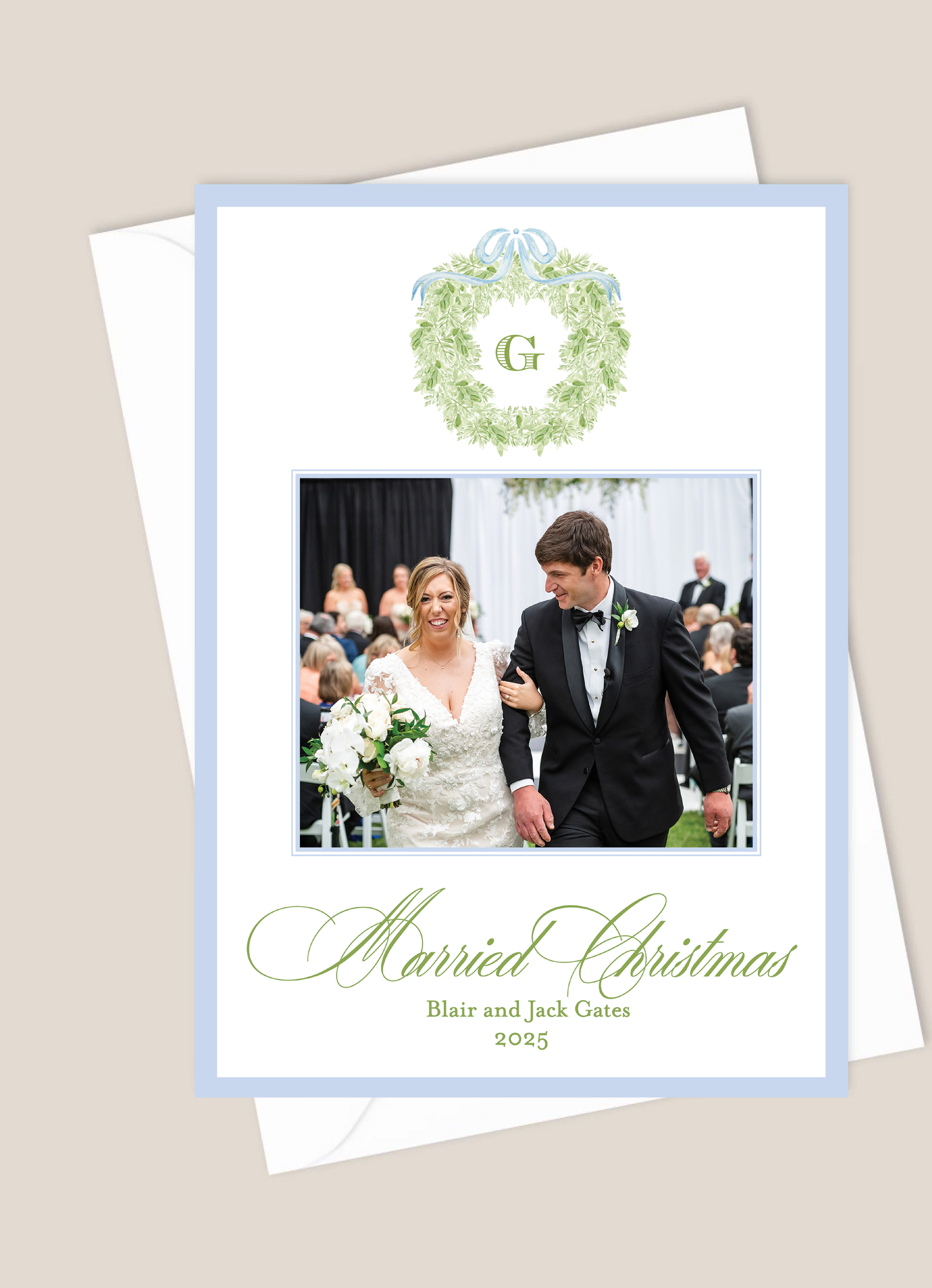 Christmas card with a photo of a bride and groom, text 'Married Christmas', and a decorative wreath with a blue border