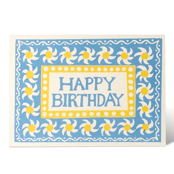 Birthday card with blue background, white flowers, and yellow centers.