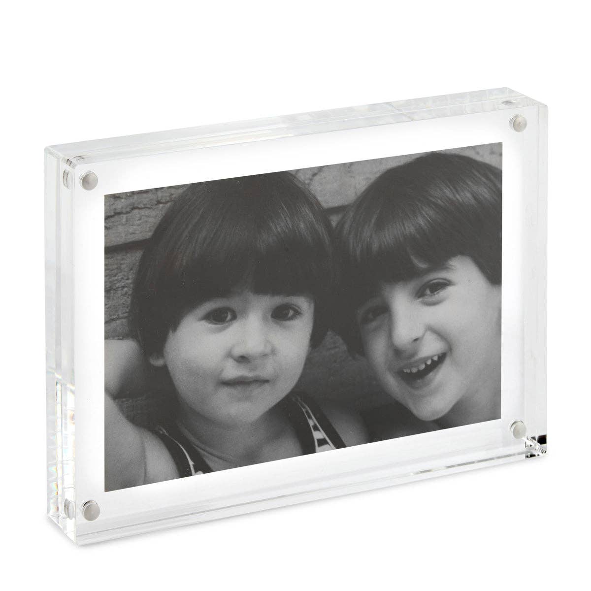 Clear acrylic photo frame with a black and white photo of two children.