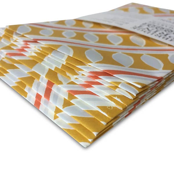 Stack of patterned paper with geometric design on a white background