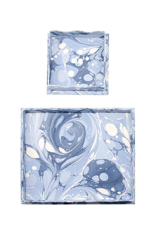 Two marbled blue and white square containers on a white background