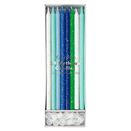 Set of colorful birthday candles in a box on a white background