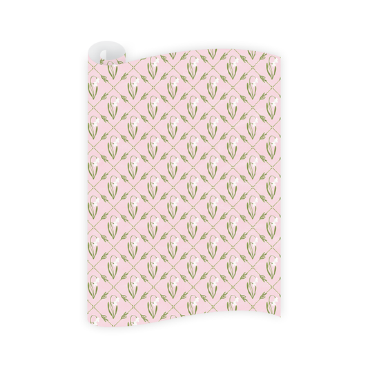 pink wrapping paper featuring a green geometric pattern on a white background