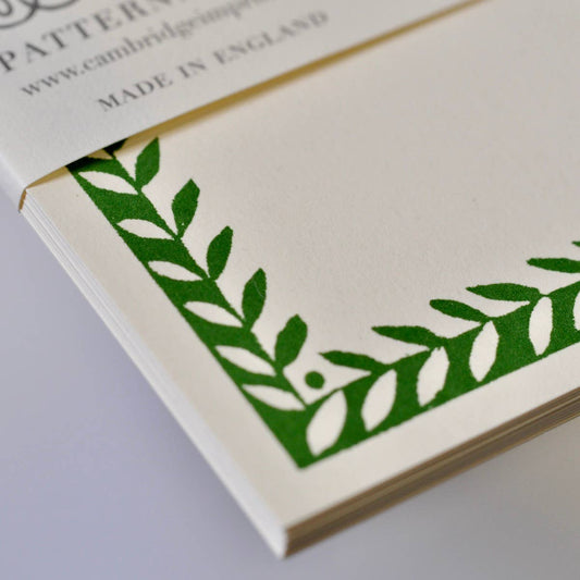 Notebook with green leaf pattern on a white background