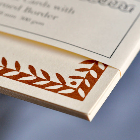 Close-up of a decorative border on a piece of paper with text.