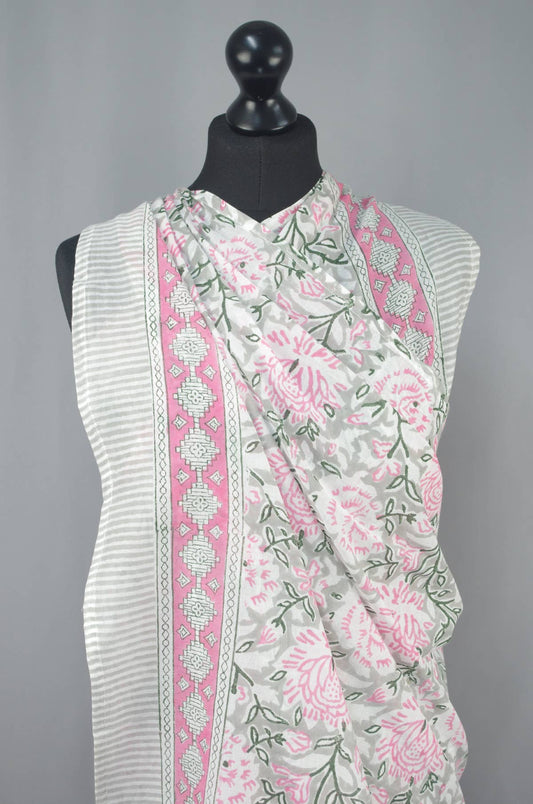 White sleeveless top with pink floral pattern on a mannequin against a gray background