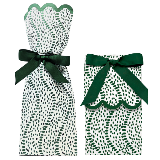 Two green and white patterned gift bags with ribbons on a white background
