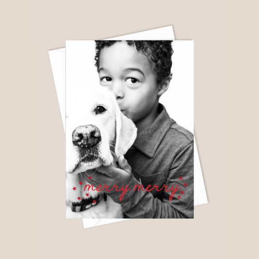 Card with a child holding a dog and 'merry merry' text on a beige background