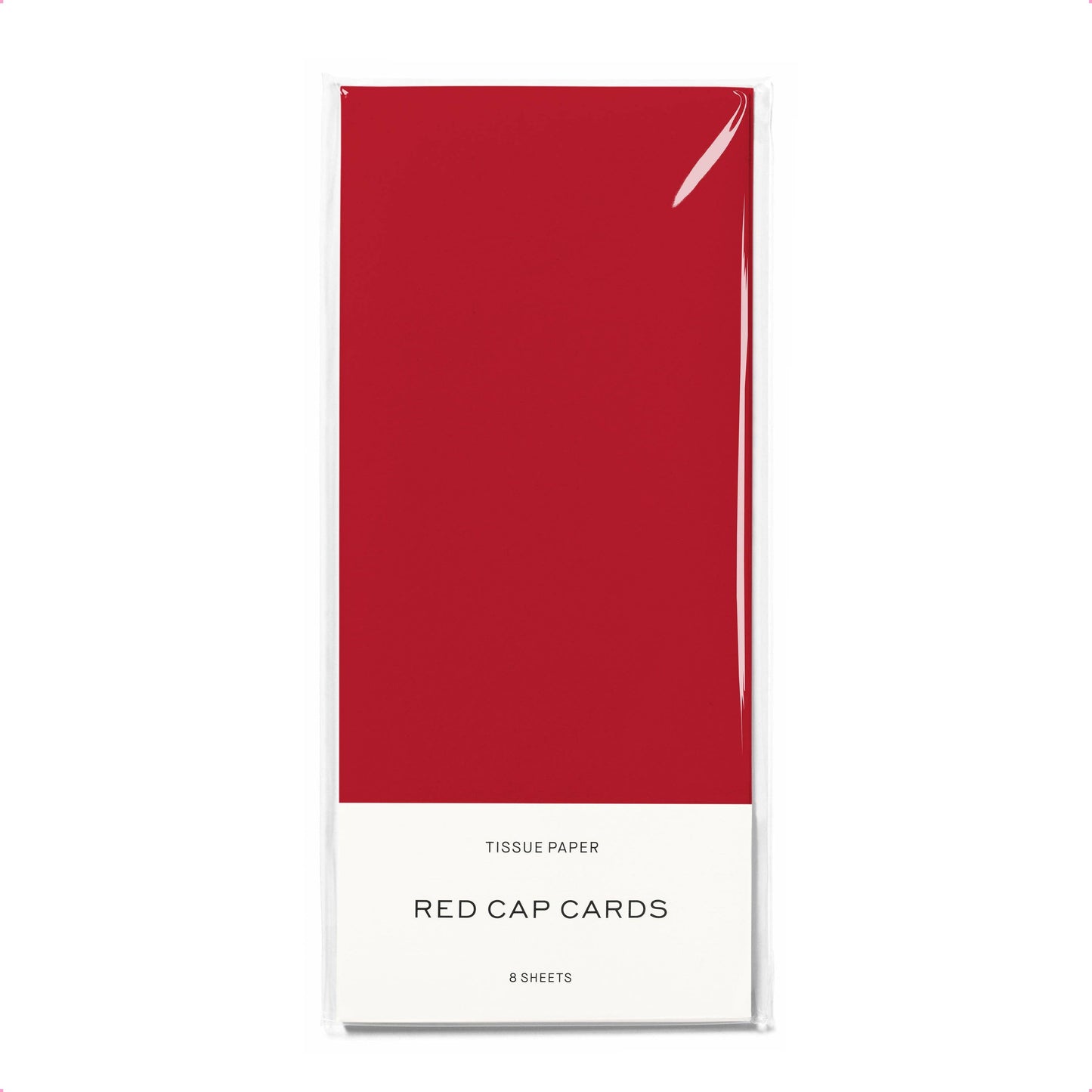 Red cap cards packaging with red tissue paper on a white background