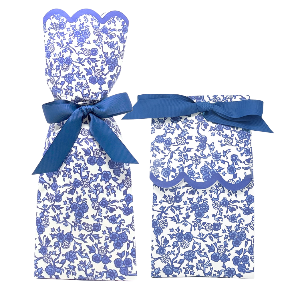 Set of blue and white floral dress and pants with a bow on a white background