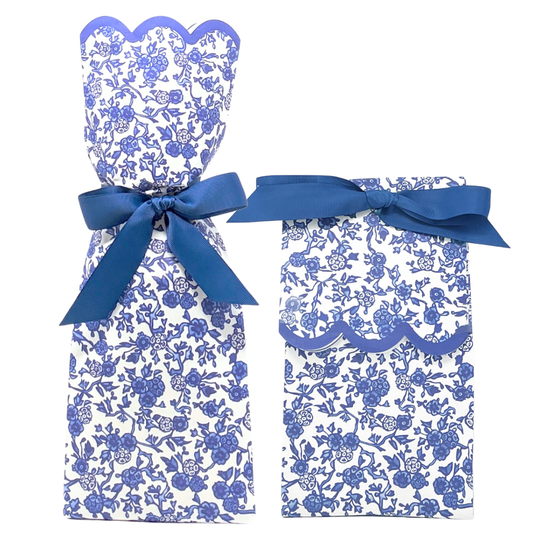 Set of blue and white floral dress and pants with a bow on a white background