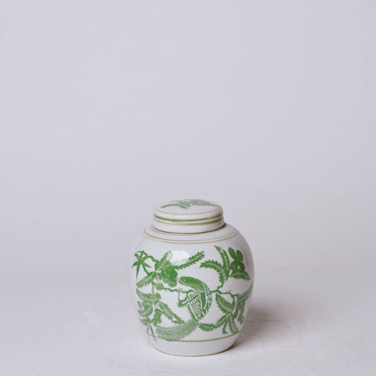 White ceramic jar with green floral patterns on a white background