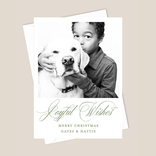 Christmas card with a photo of a child holding a dog and the text 'Joyful Wishes Merry Christmas"