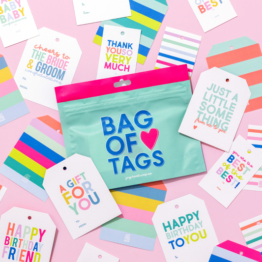 Colorful gift tags and a bag labeled 'Bag of Tags' on a pink background