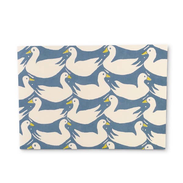 Patterned paper with white ducks on a blue background