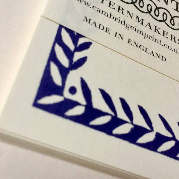 Product packaging with blue leaf design and 'Cambridge Imprint' branding.