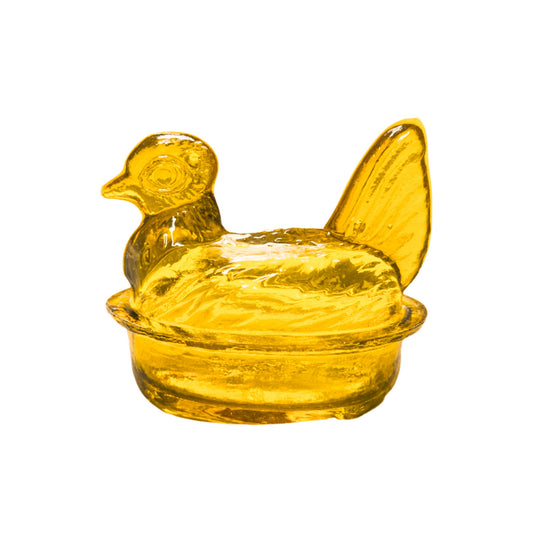 Yellow glass chicken-shaped container on a white background