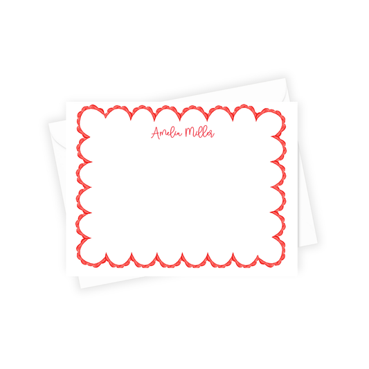 White pillow with red scalloped border and 'Amelia Miller' text on a white background