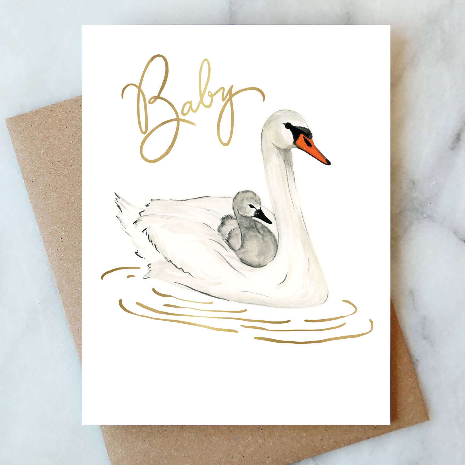 Card with a swan and cygnet illustration and 'Baby' text on a marble surface.