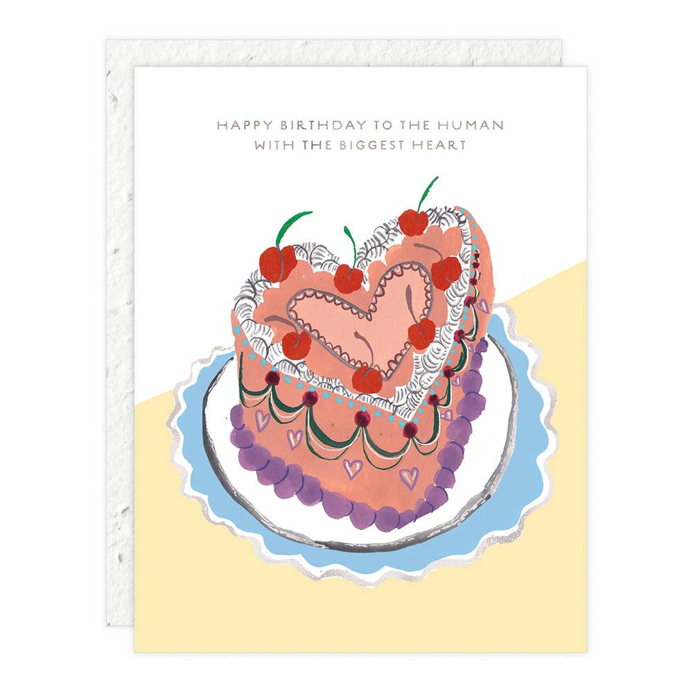 Heart shaped cake on a white and yellow background with text saying "Happy Birthday to the Human with the Biggest Heart"