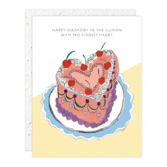 Heart shaped cake on a white and yellow background with text saying "Happy Birthday to the Human with the Biggest Heart"