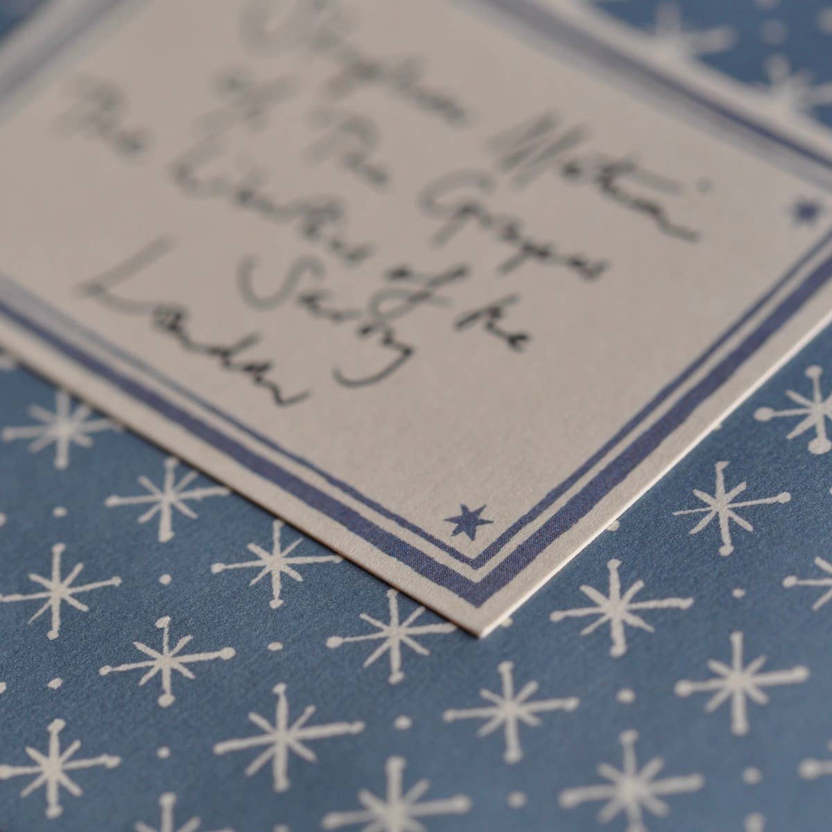 Close-up of a blue card with white star pattern and text