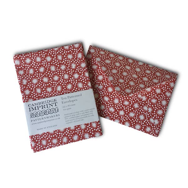 Two red patterned envelopes with a Cambridge Imprint label on a white background