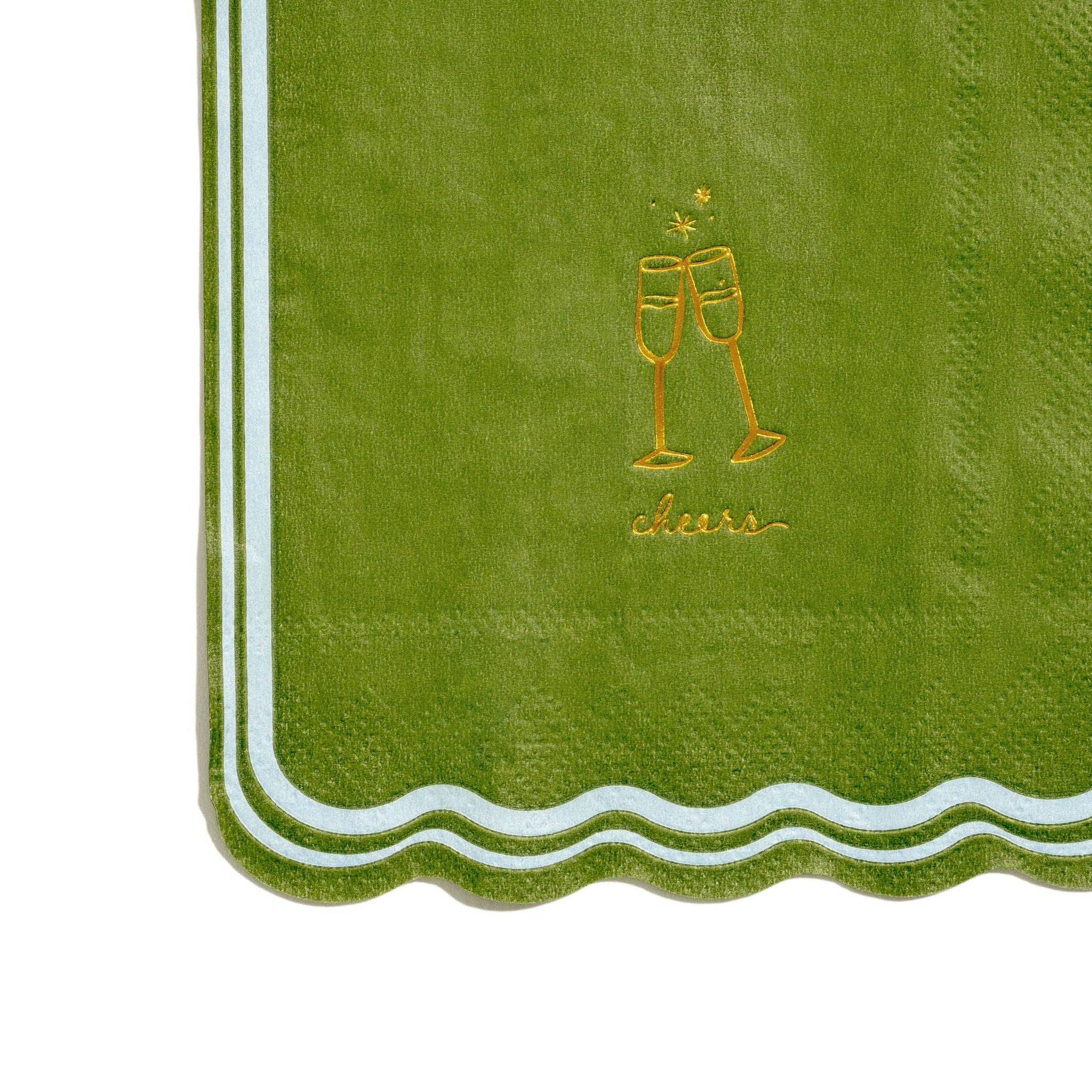 Green napkin with gold 'cheers' and champagne glass design on a white background