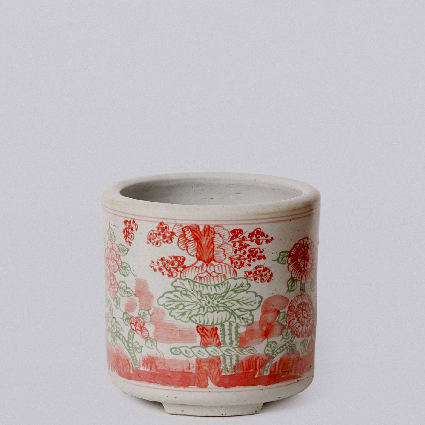 Ceramic pot with floral design on a white background