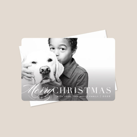 Christmas card with a photo of a child holding a dog and the text 'Merry Christmas' 