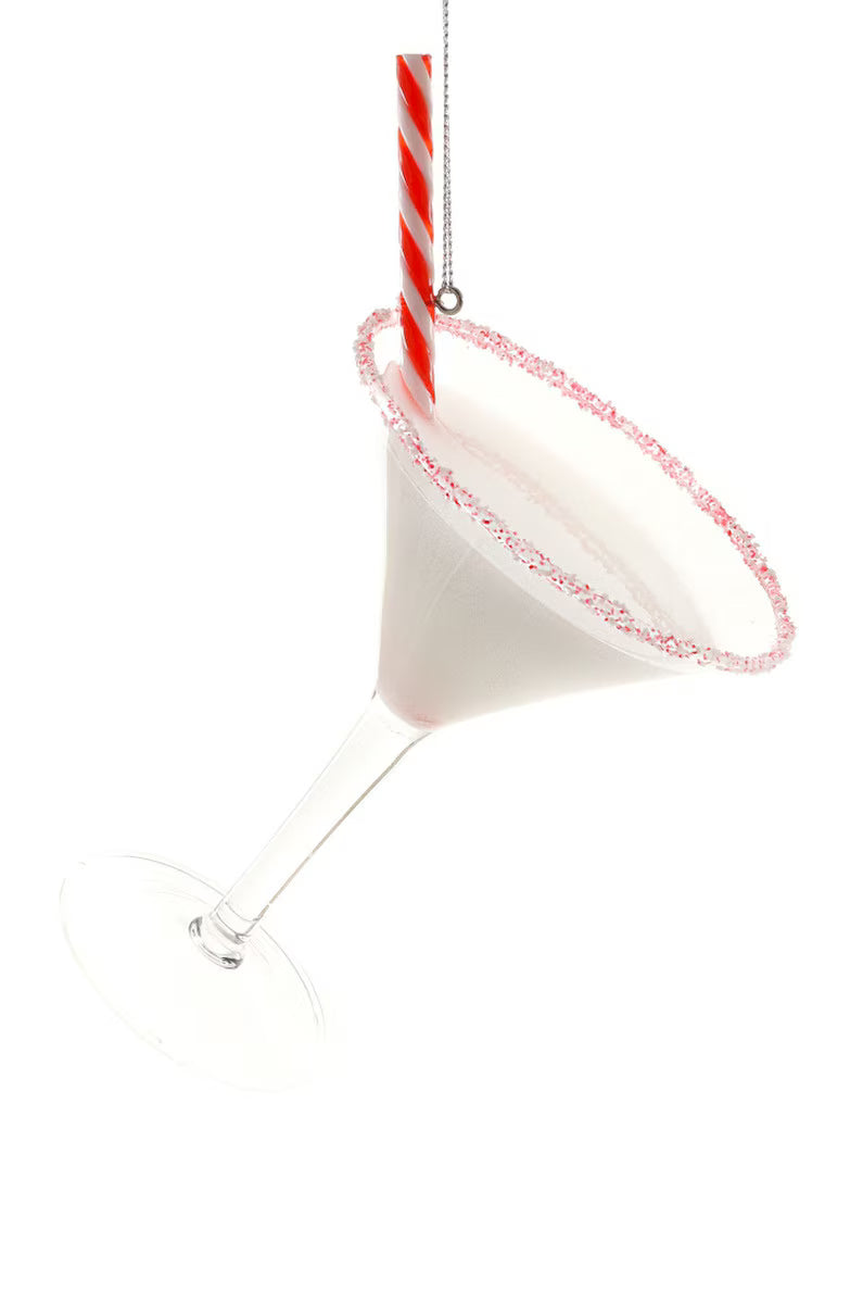 A clear martini-style glass ornament with a white interior and a red-and-white striped straw, shown against a plain white background.