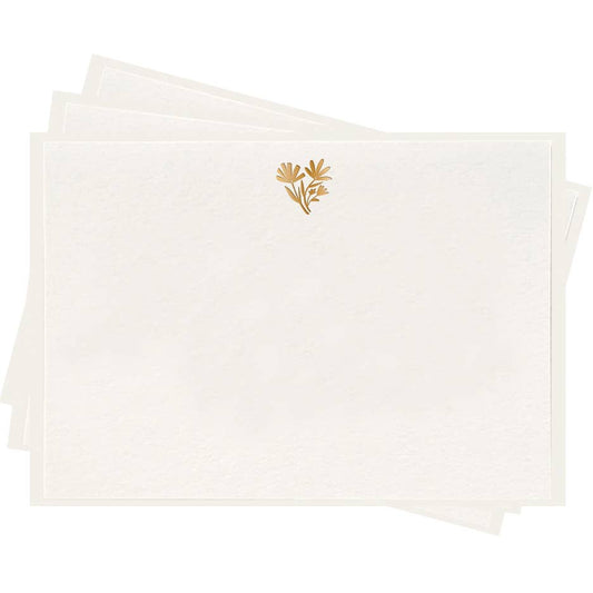 White paper with a gold floral design on a white background