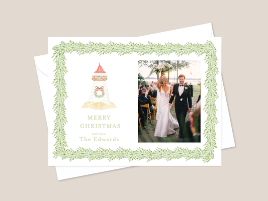 Holiday card with lighthouse and wreath with greenery and couple picture