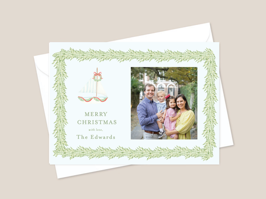 Christmas card with sailboat wreath and greenery