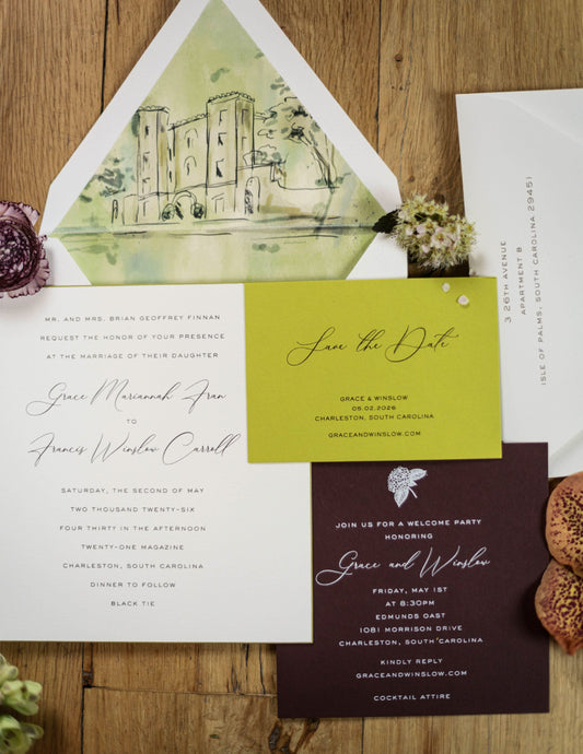 A styled flat-lay of a wedding invitation suite on a rustic wood background, featuring a white envelope with a watercolor castle illustration, a white invitation card, a bright yellow save-the-date card, a dark burgundy party invitation card, and small decorative floral and cork props.