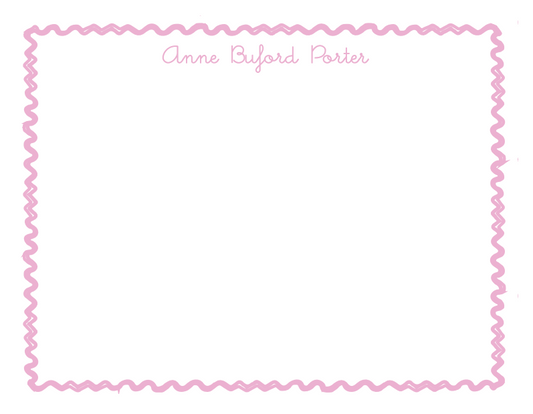 Nameplate with a pink zigzag border and text on a white background