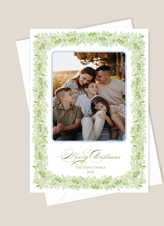Christmas card with a family photo and decorative green border 