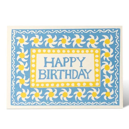 Birthday card with blue background, white flowers, and yellow centers.
