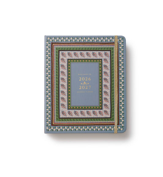 A decorative 2026-2027 daily planner with a blue-gray center panel and an ornate multicolor border pattern, shown closed on a white background with a soft shadow.