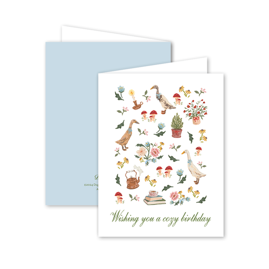 Greeting card with nature-themed illustrations and a blue envelope on a white background