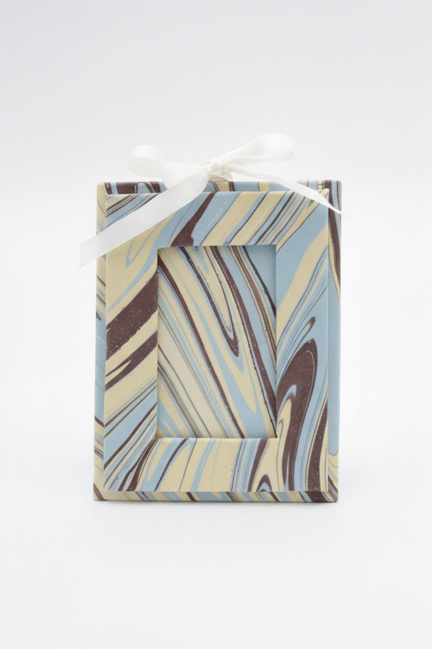 Marbled patterned gift box with a ribbon on a white background