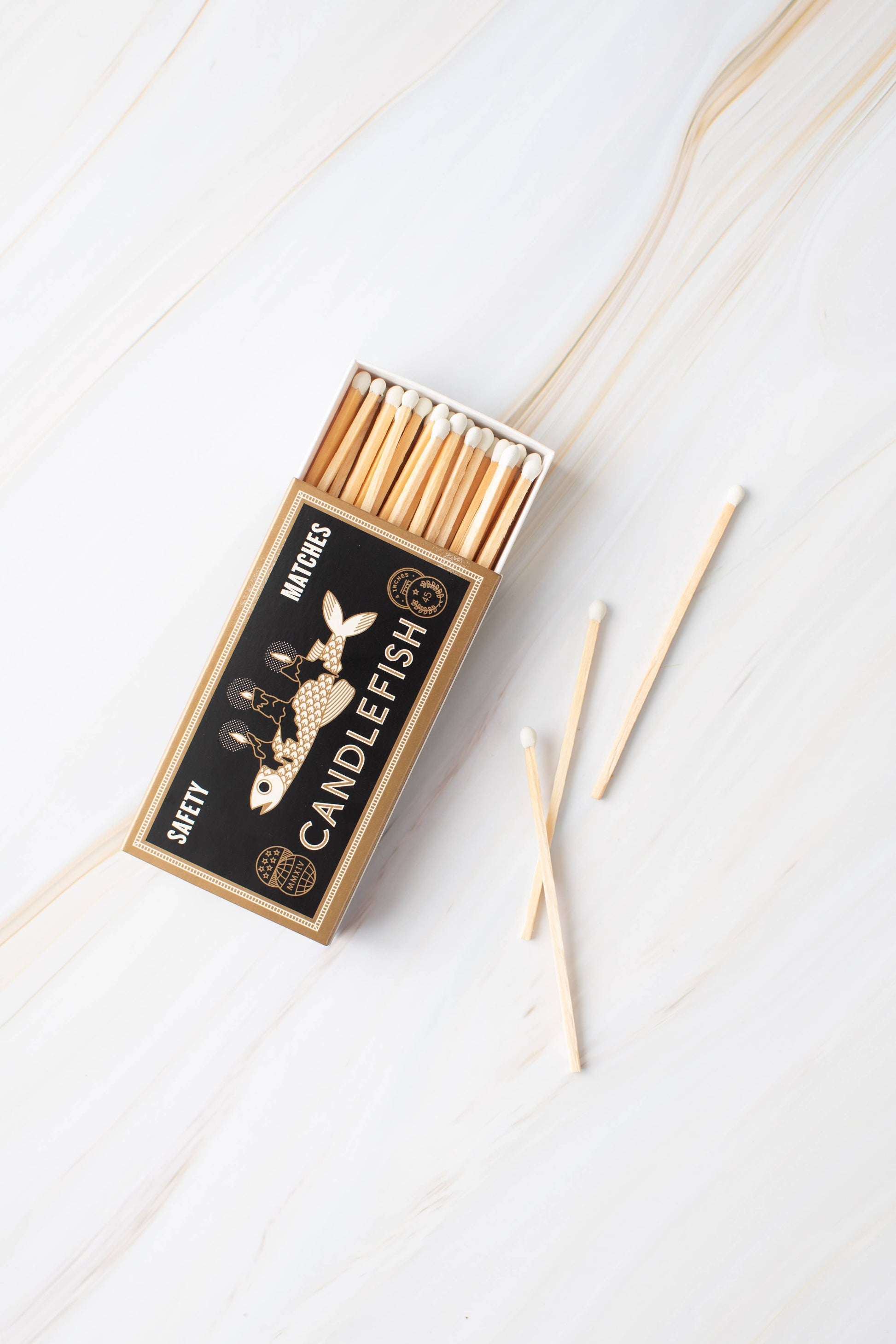 Box of matches with 'Candlefish' branding on a white background