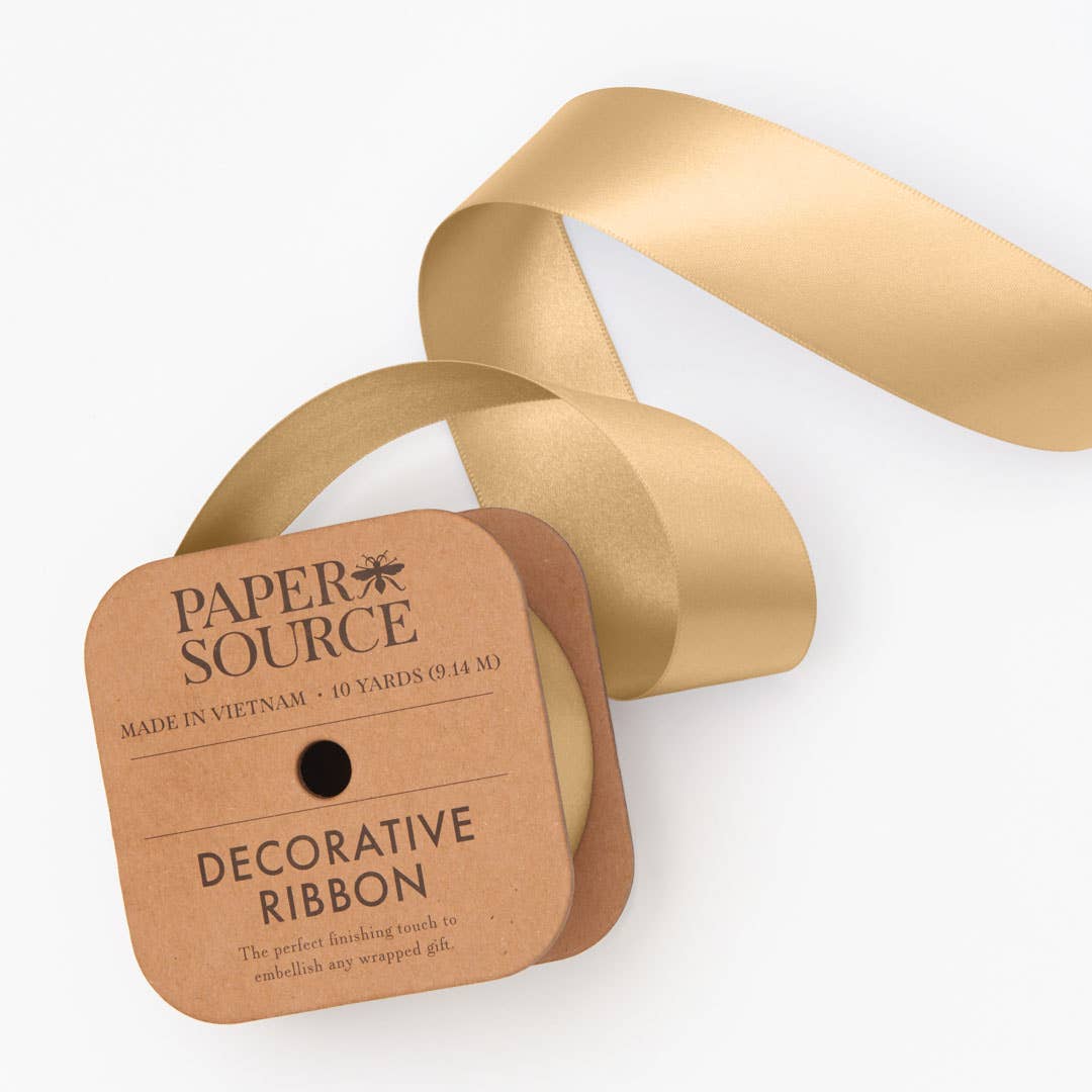 Gold decorative ribbon with Paper Source packaging on a white background