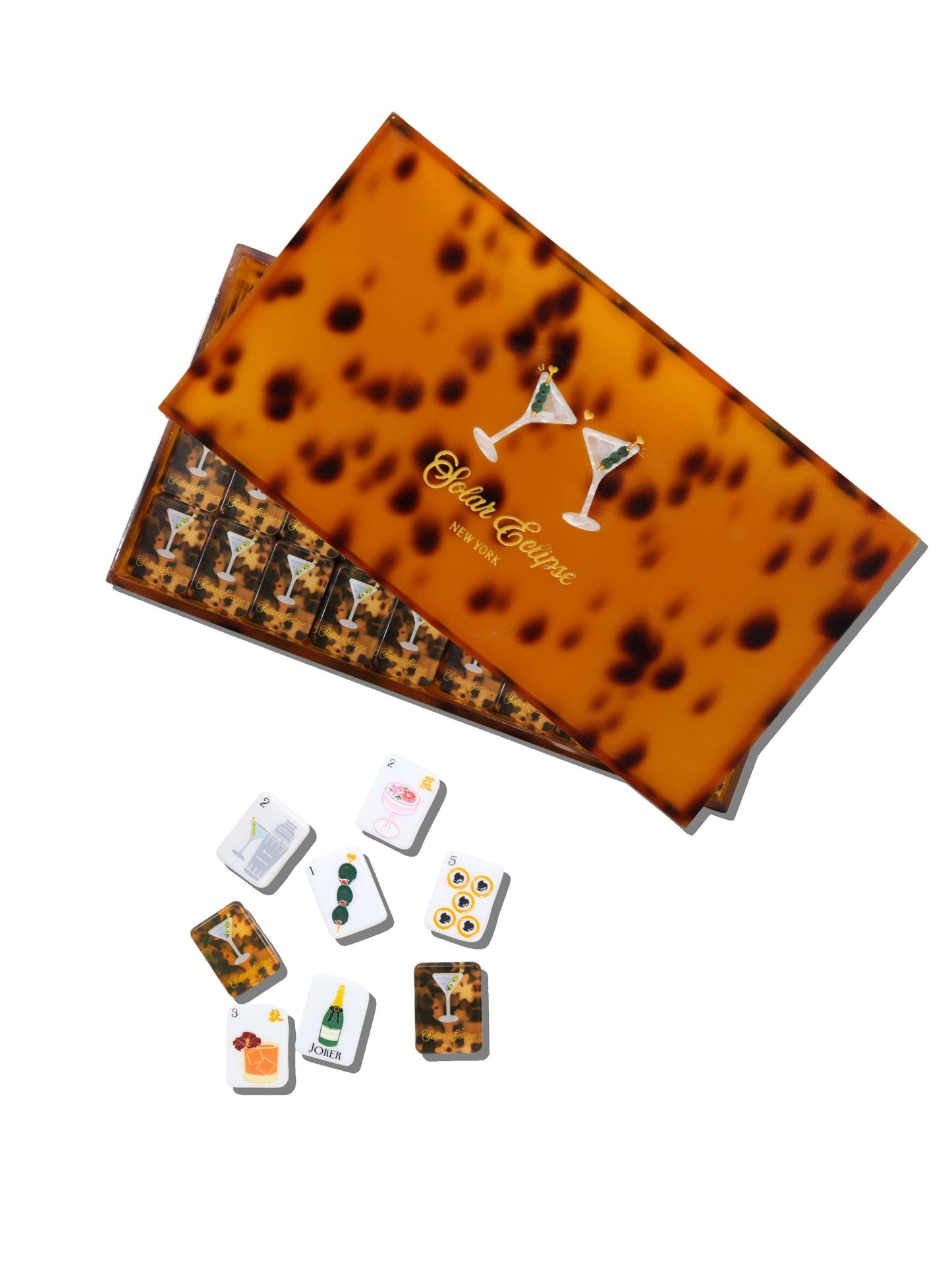 A boxed set of cocktail-themed playing cards with a tortoiseshell-patterned box lid and several individual cards displayed below on a white background.