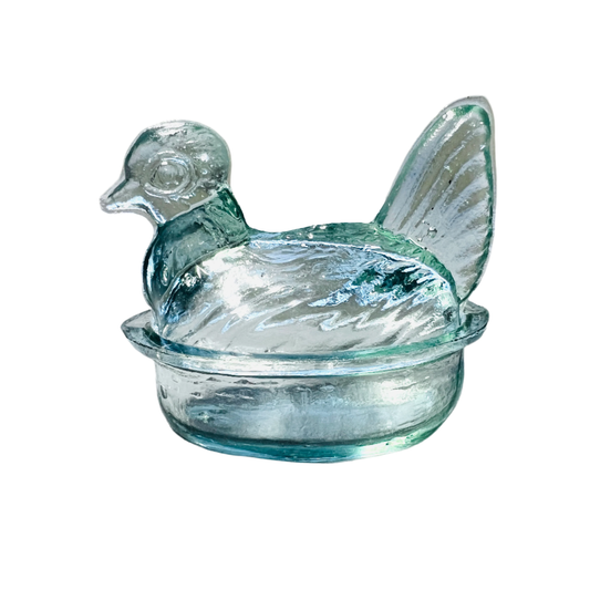 Clear glass container shaped like a chicken on a white background