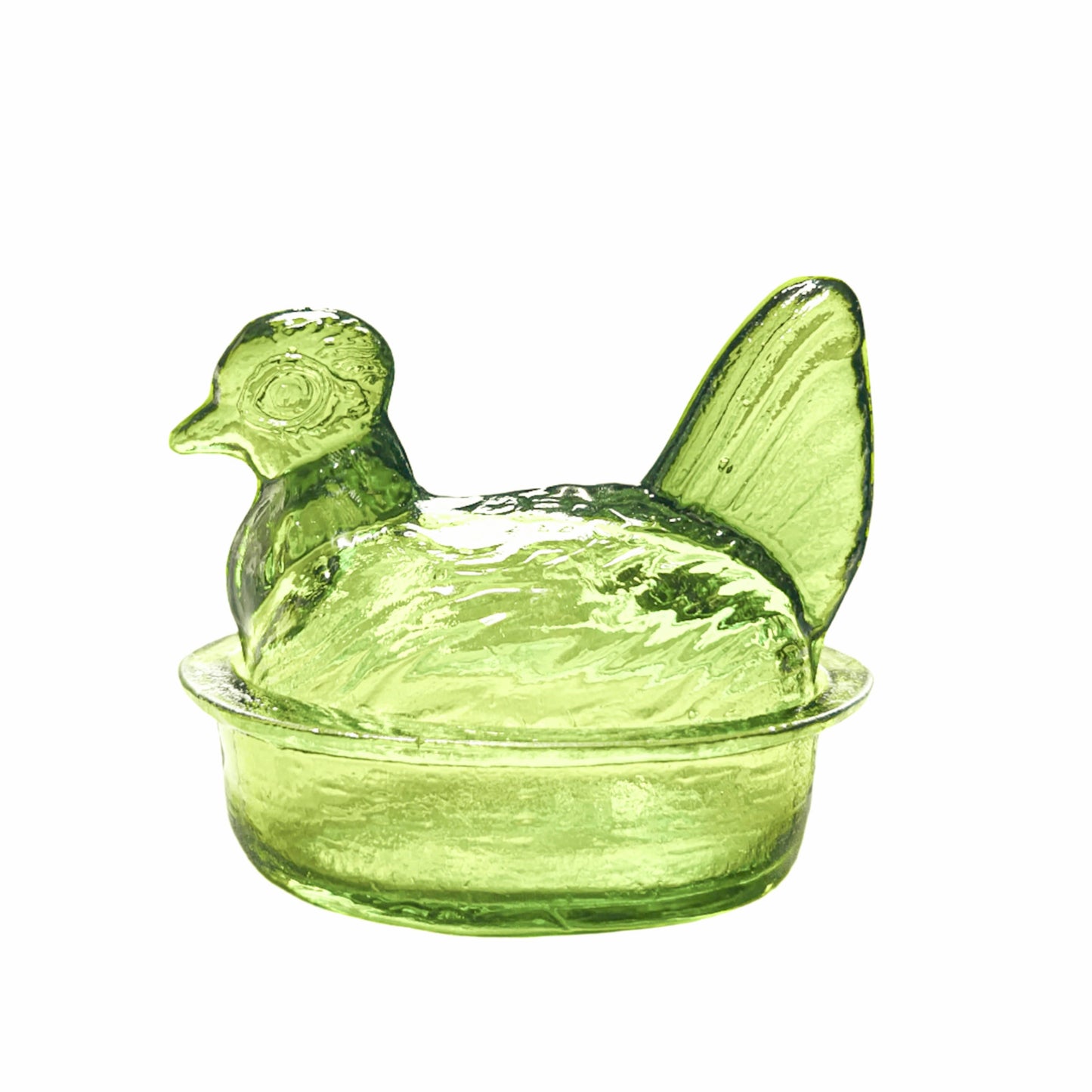 Green glass chicken-shaped container on a white background