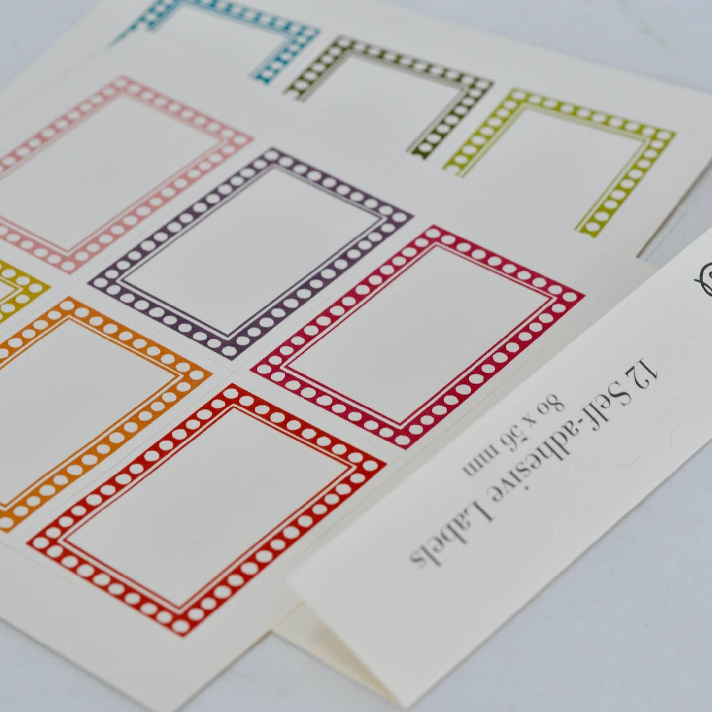 Colorful square labels on a white card with text